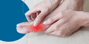 A woman touching her foot with a red glow indicating pain