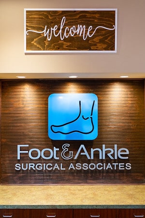 Foot & Ankle Surgical Associates logo in a clinic entryway